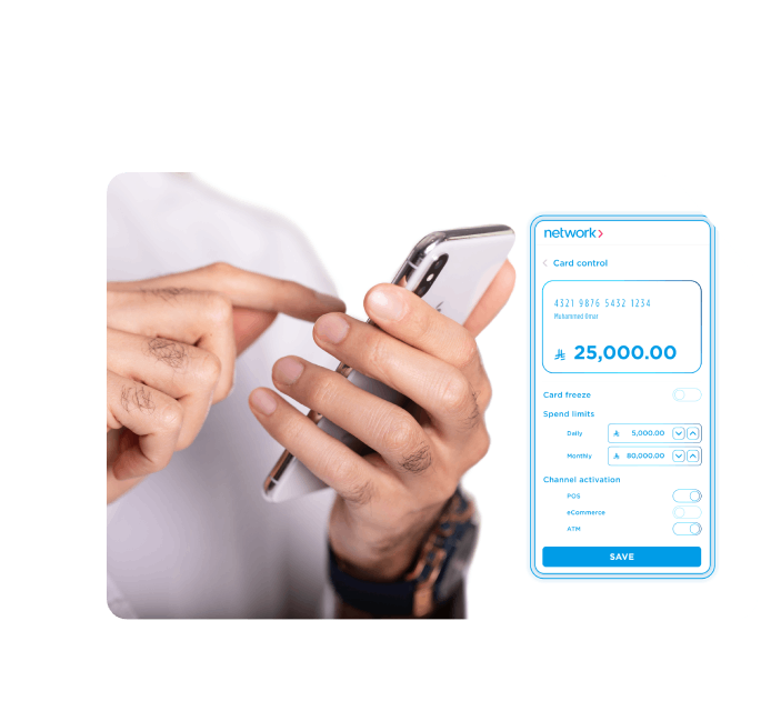 Man using smartphone with a holographic Network card control interface showing balance, spend limits, and activation options.