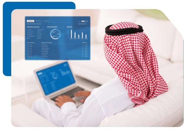 Gulf man on white couch using laptop showing data dashboard or chart.