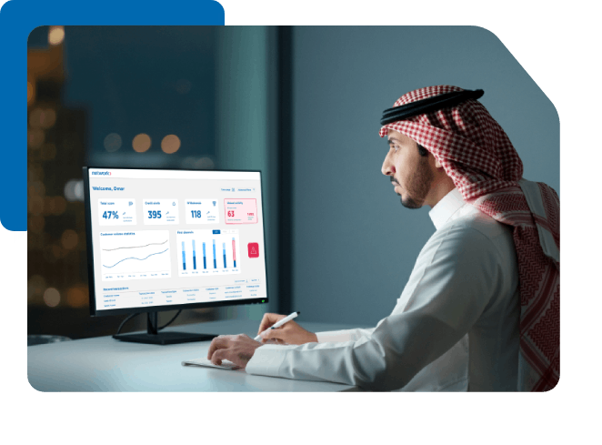 Saudi man analyzing business dashboard with charts and KPIs on computer.