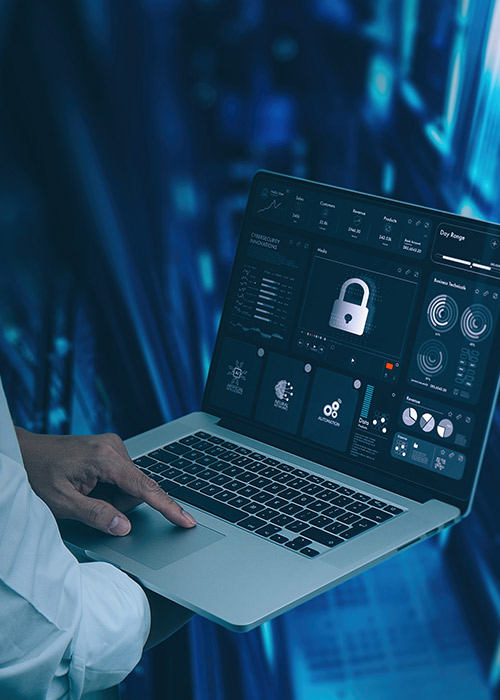Person using laptop displaying cybersecurity dashboard interface.